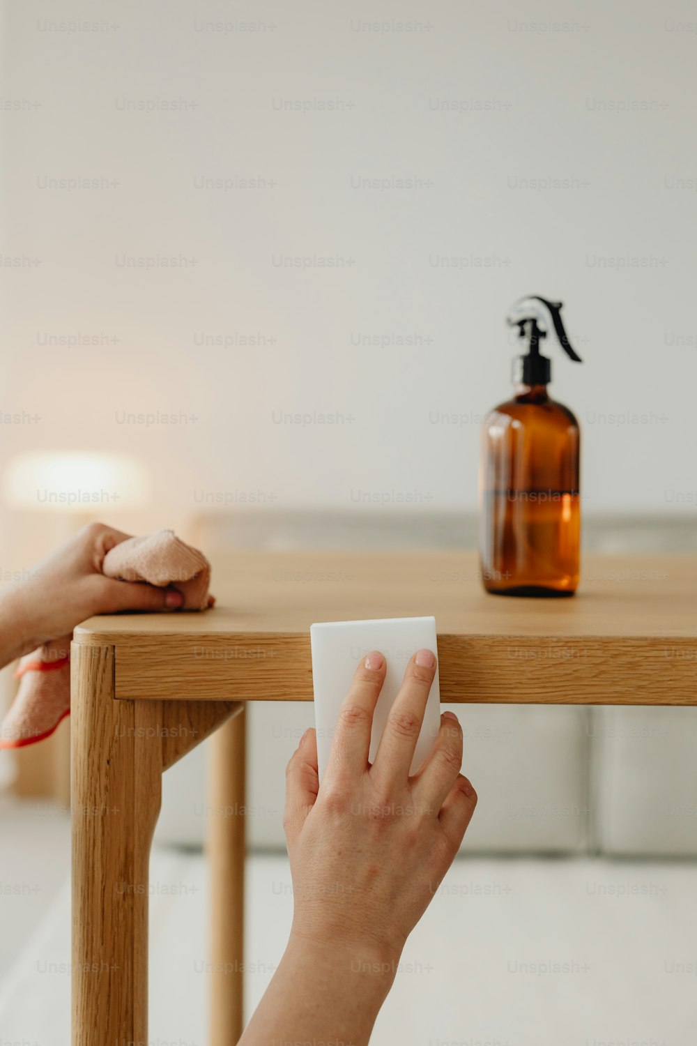 a person is sitting at a table with a soap dispenser