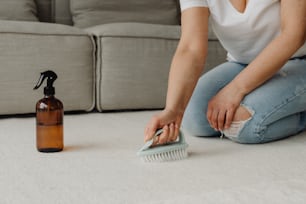 a woman is cleaning the floor with a brush