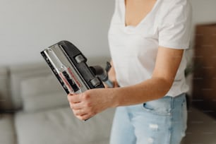 a woman is holding a tool in her hand