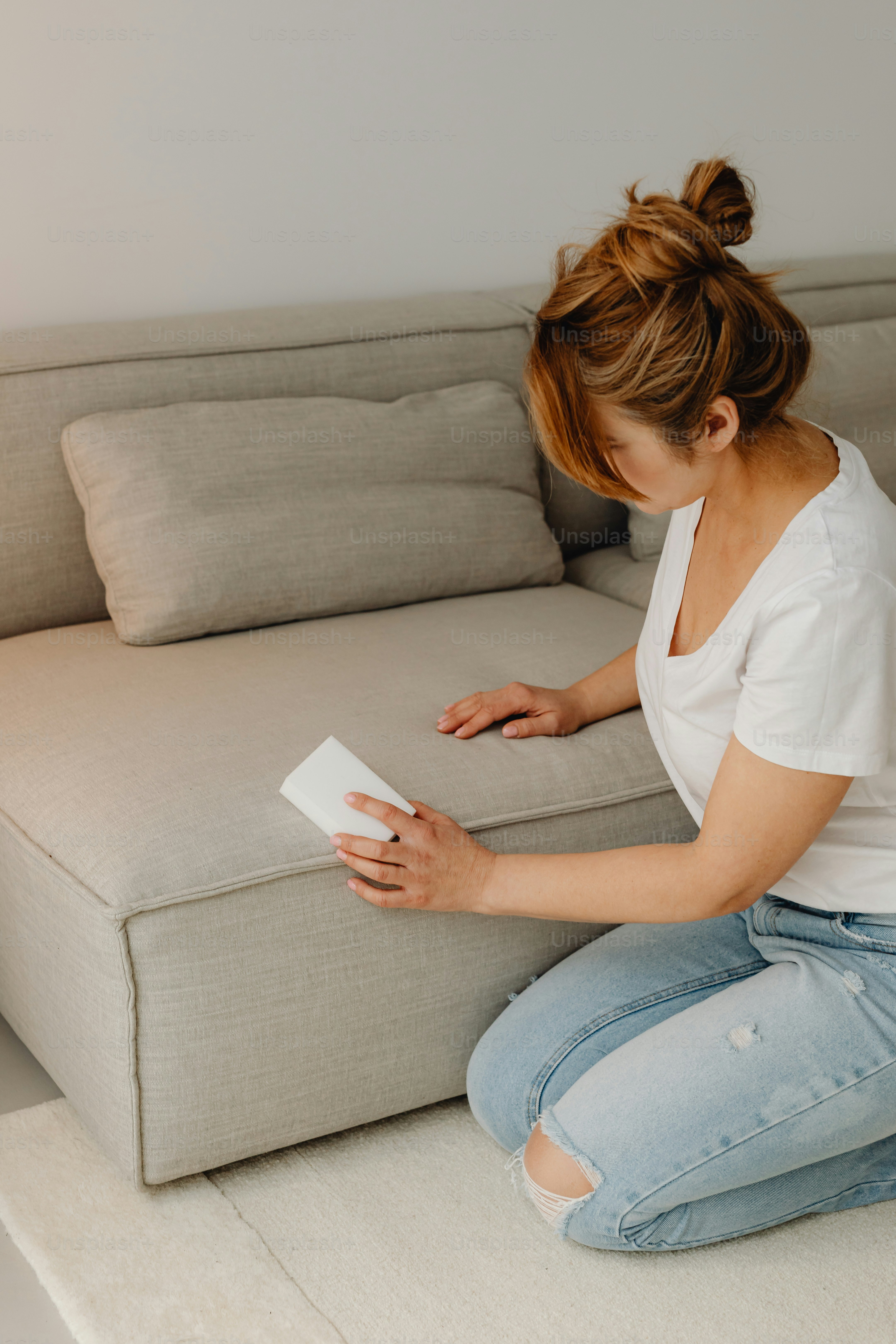 a woman sitting on a couch reading a book