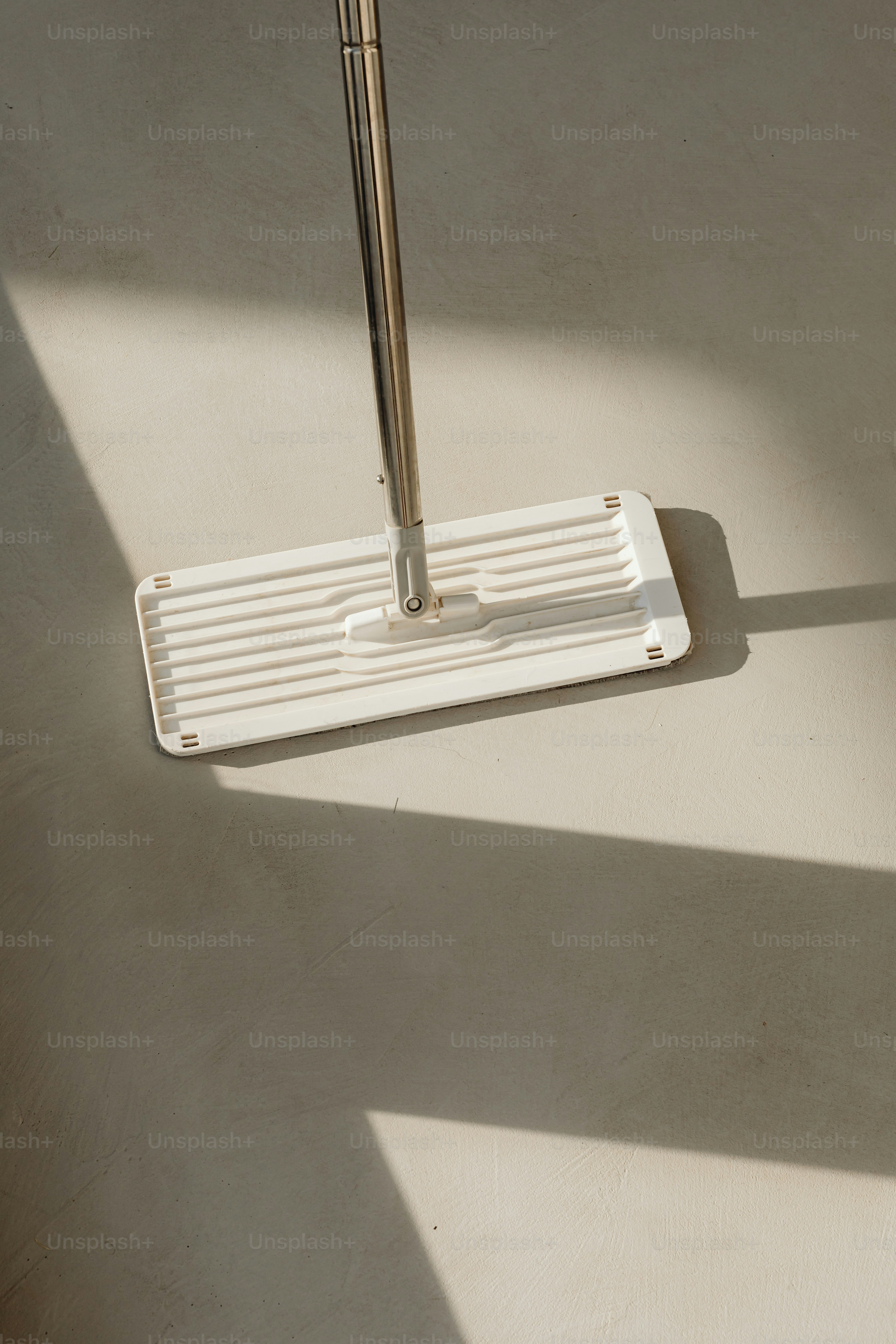 a white umbrella on a white floor in a room