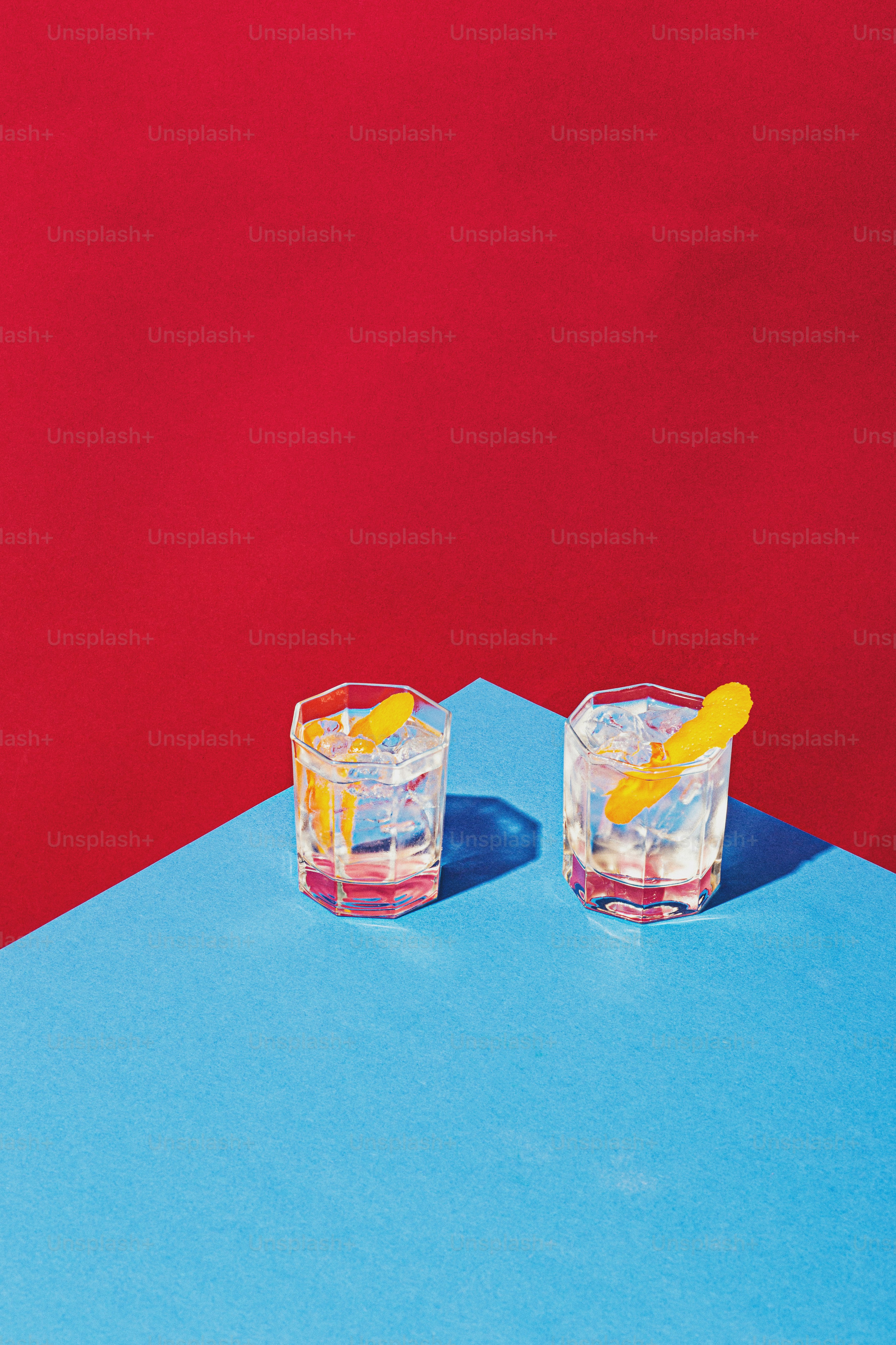 two glasses of water with a lemon wedge in them