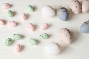 a white table topped with lots of different colored eggs