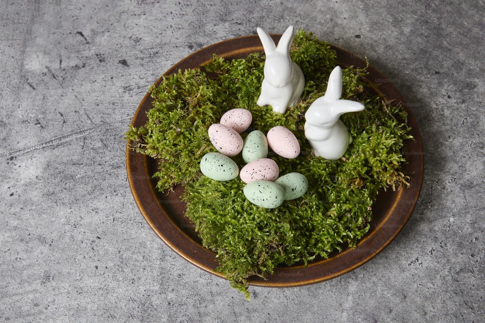 a plate of moss with eggs and rabbits on it