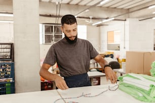 a man in a factory working on a piece of paper