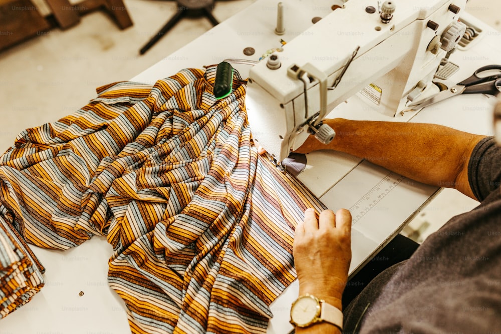 a man is working on a sewing machine