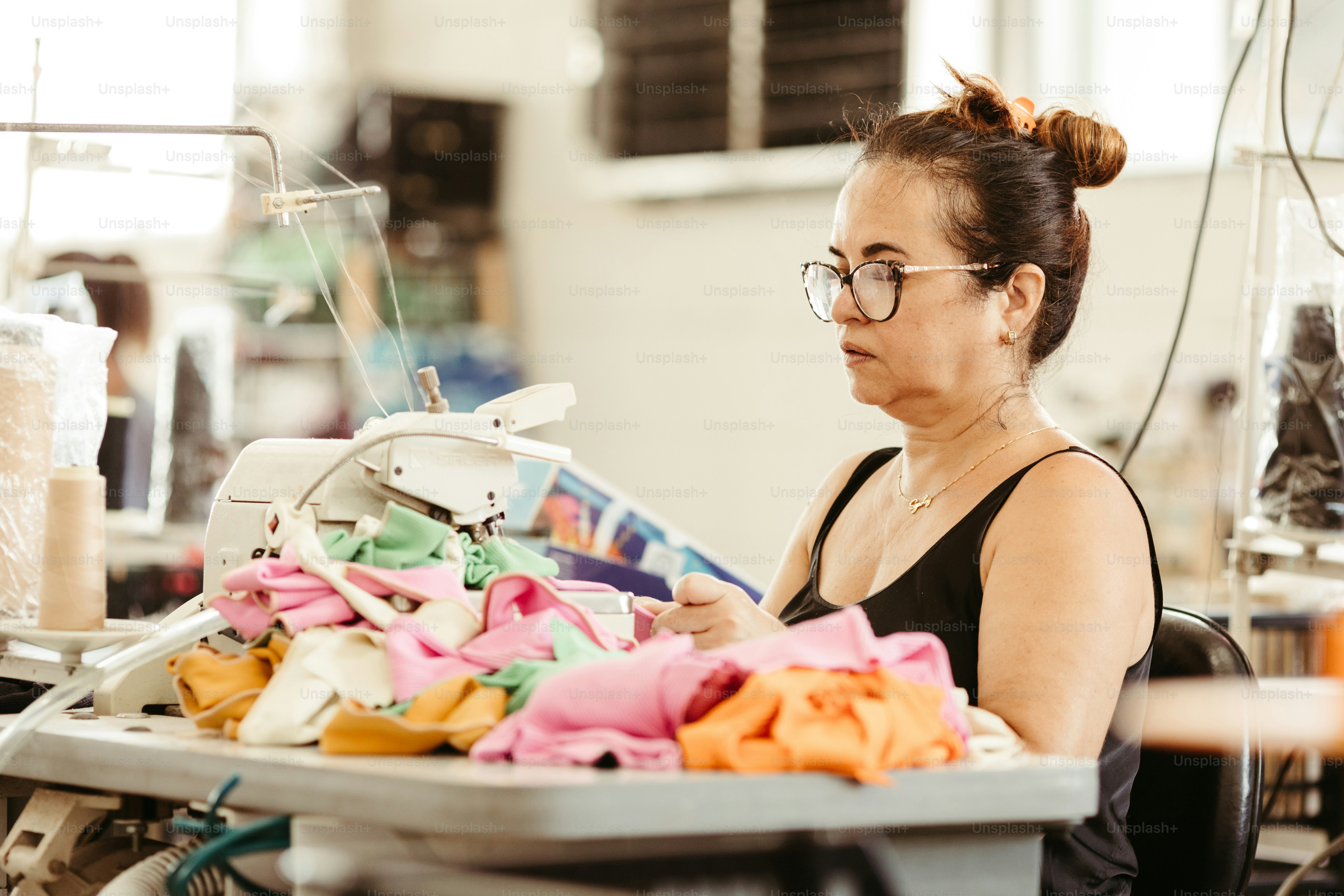 a woman is working on a sewing machine
