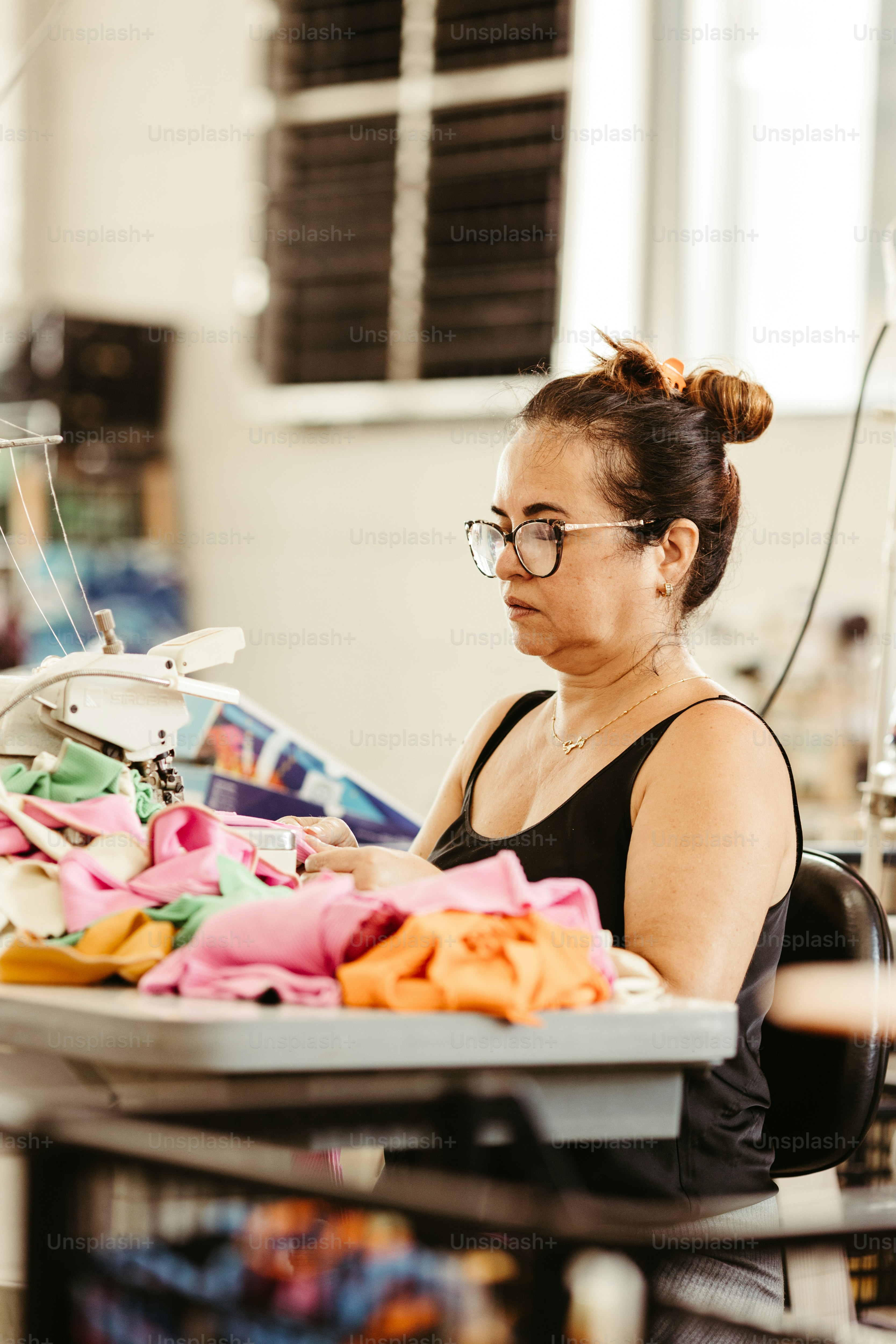 a woman sitting in front of a sewing machine
