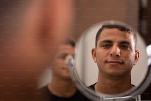 a man looking at himself in the mirror