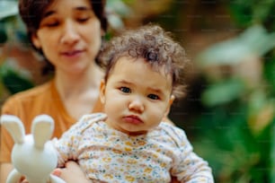 a woman holding a baby in her arms