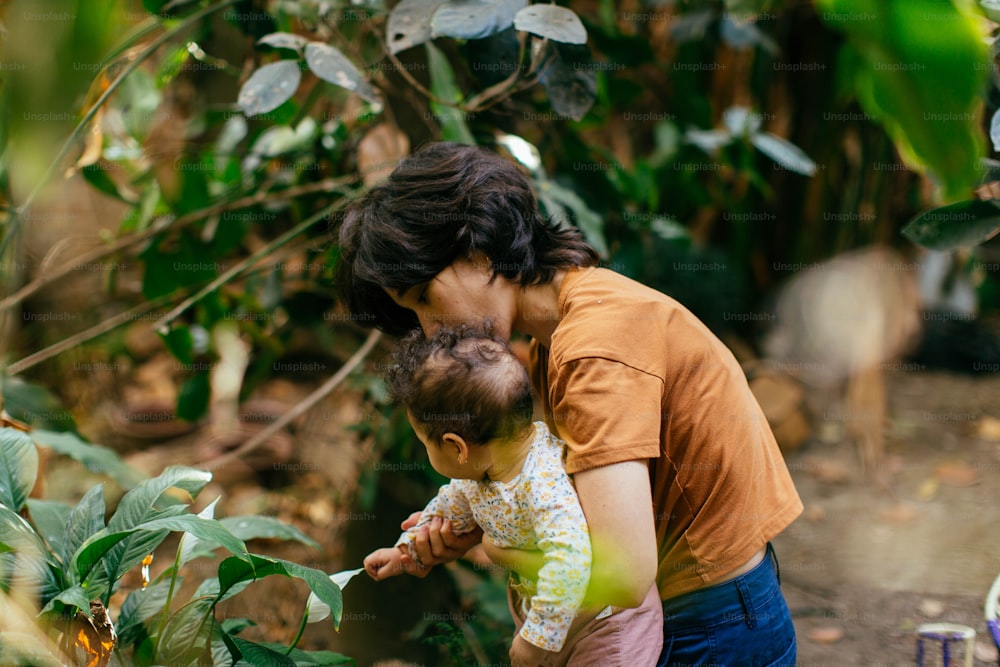 a woman holding a baby in her arms