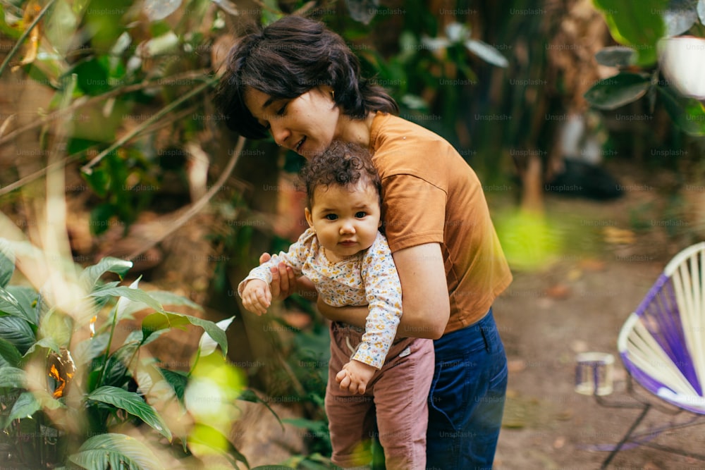 a woman holding a baby in her arms