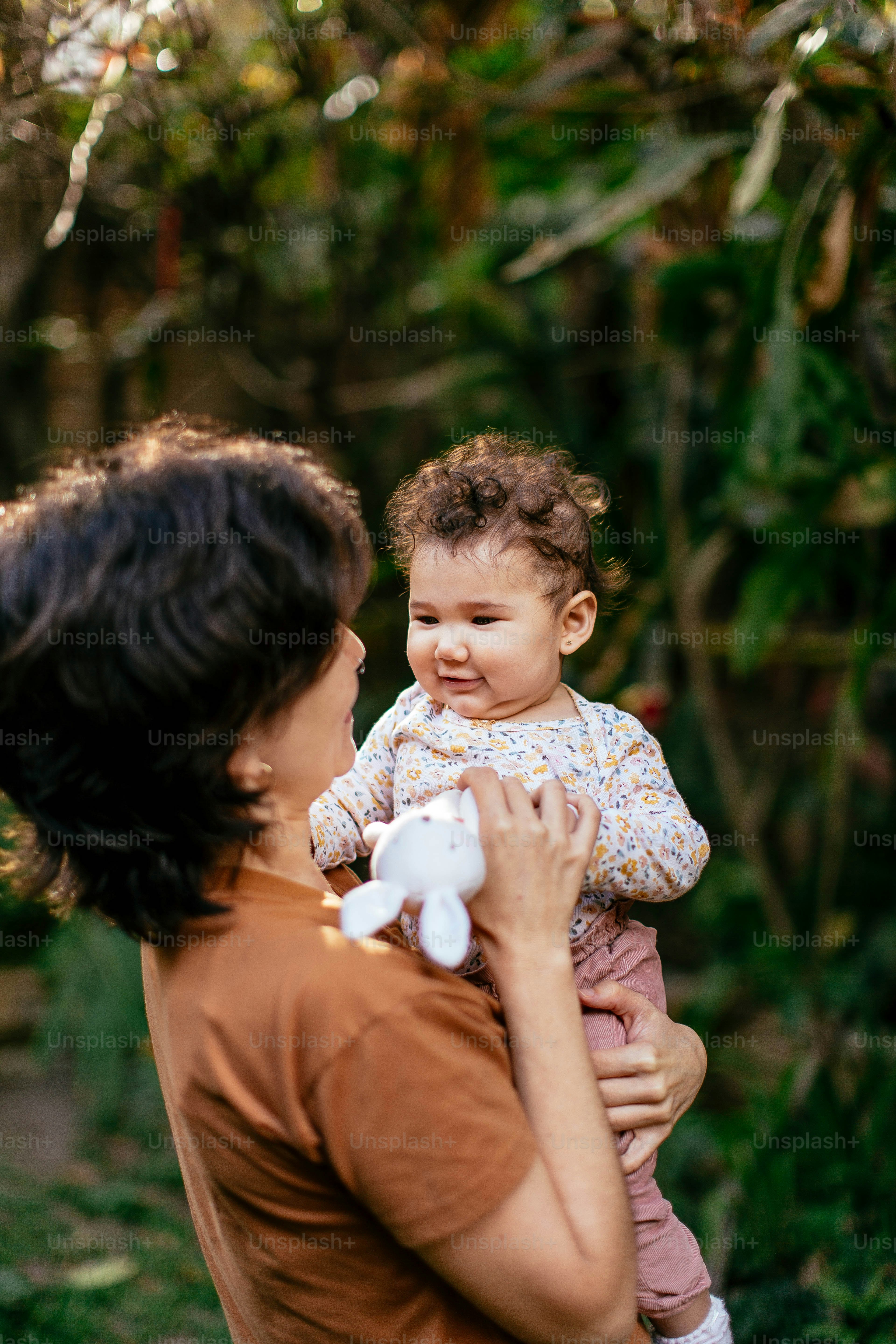 a woman holding a baby in her arms