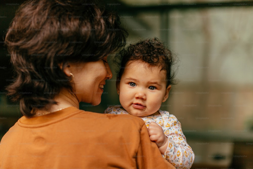 a woman holding a baby in her arms