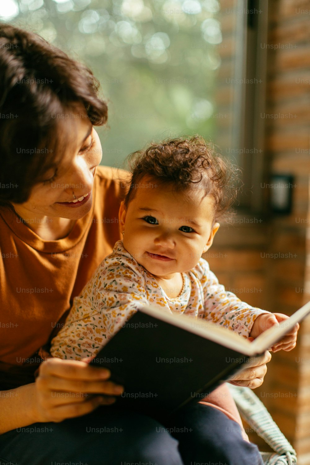 a woman reading a book to a baby