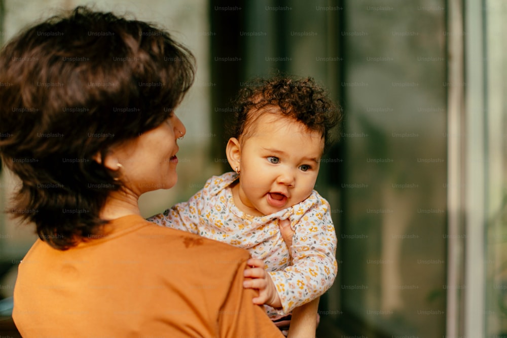 a woman holding a baby in her arms