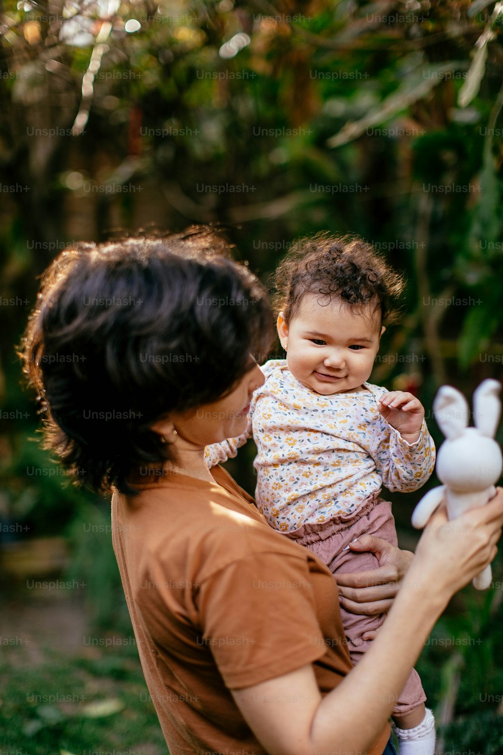 a woman holding a baby in her arms