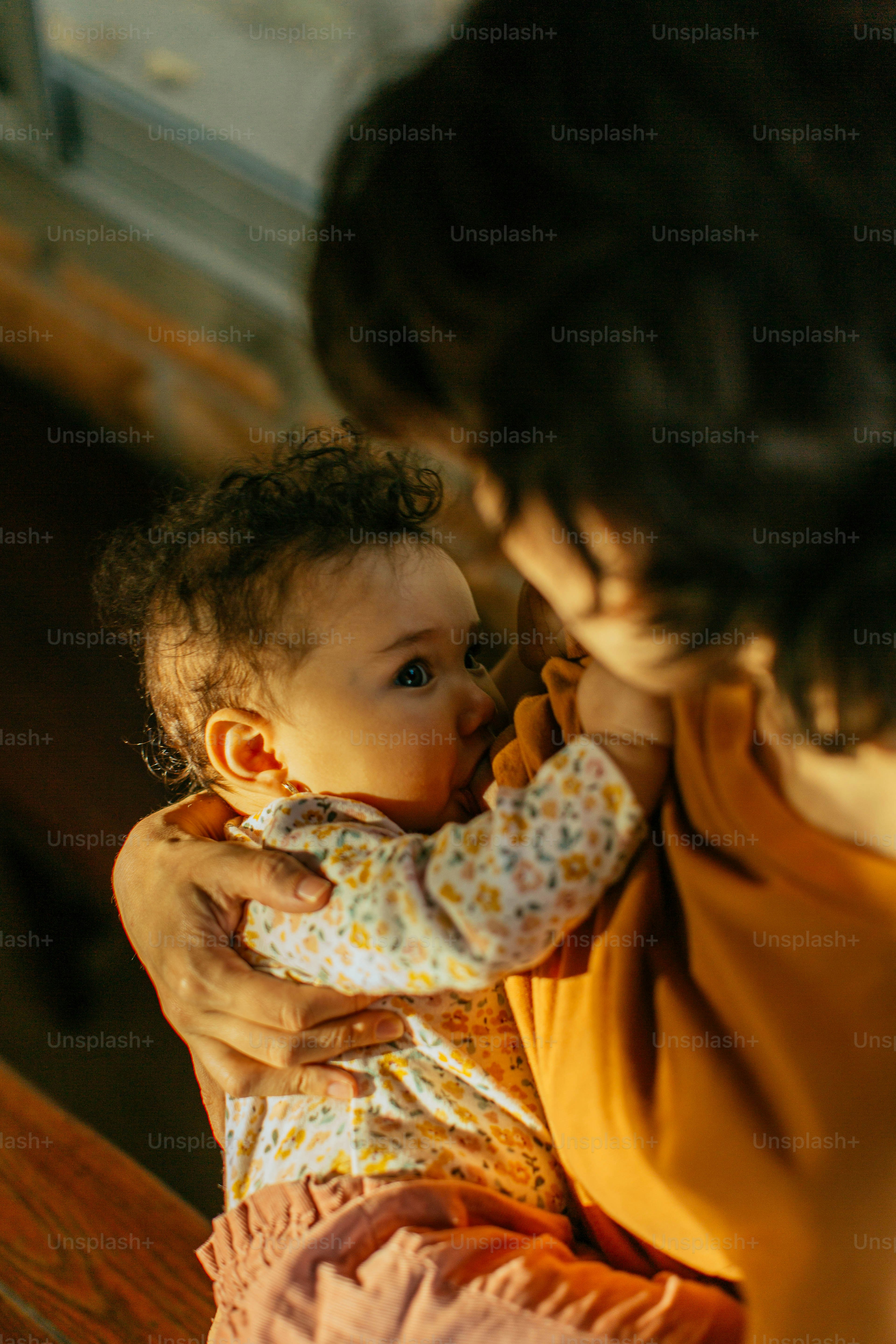 a woman holding a baby in her arms