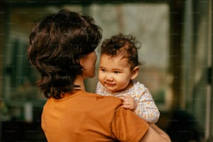 a woman holding a baby in her arms