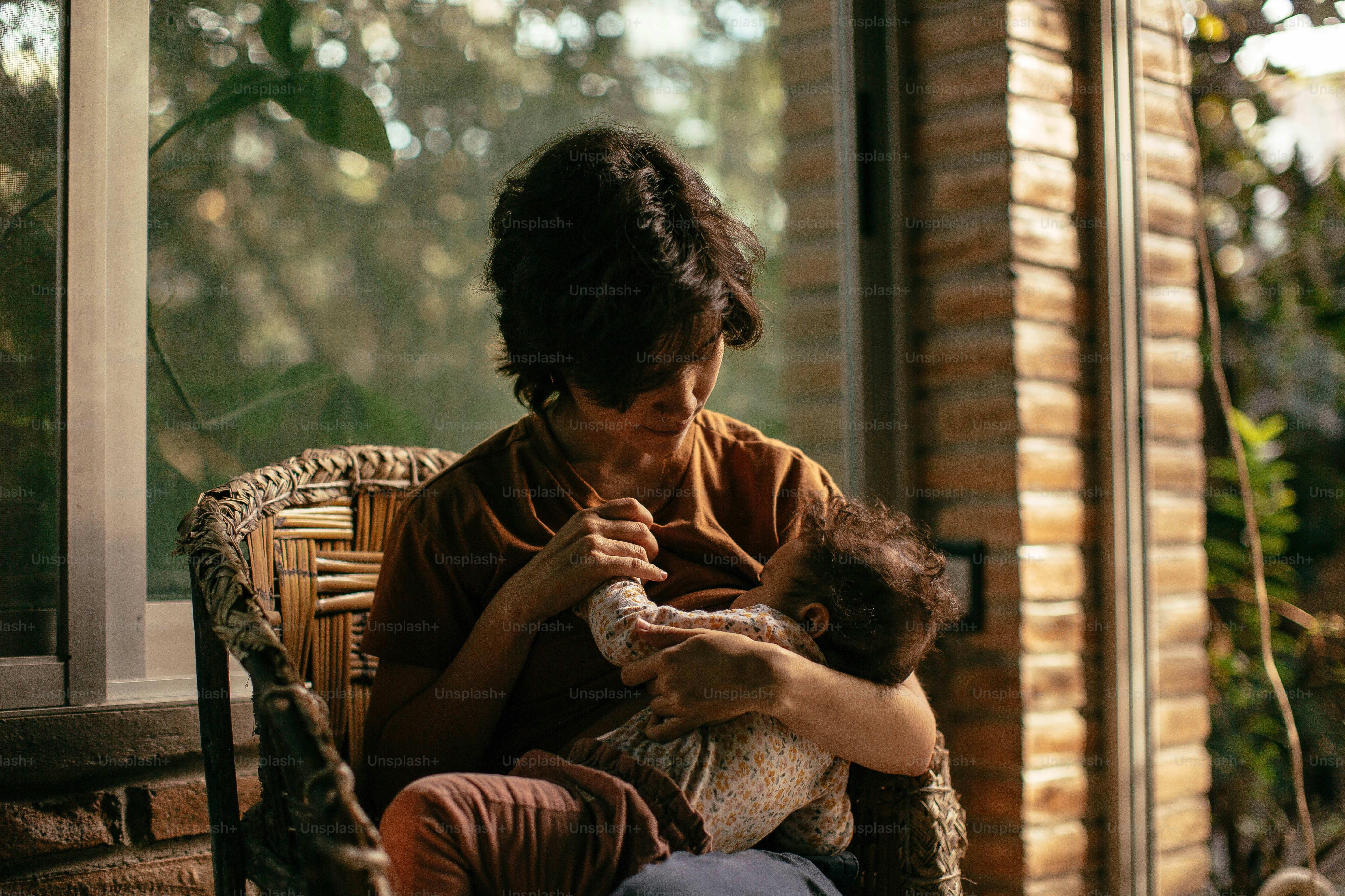 a woman sitting on a chair holding a baby