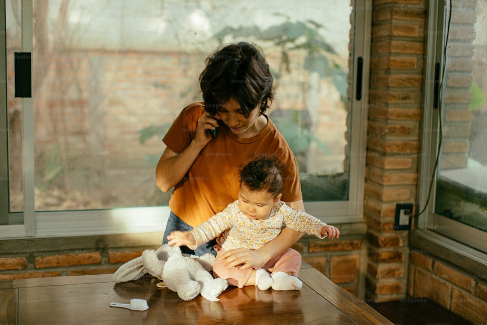 a woman and a child sitting on a table