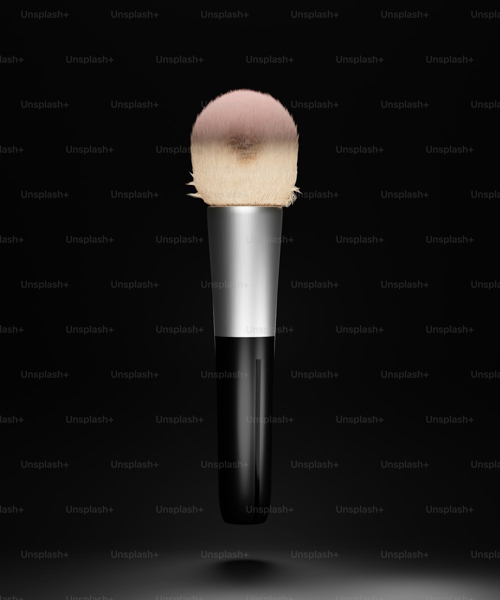 a close up of a makeup brush on a black background