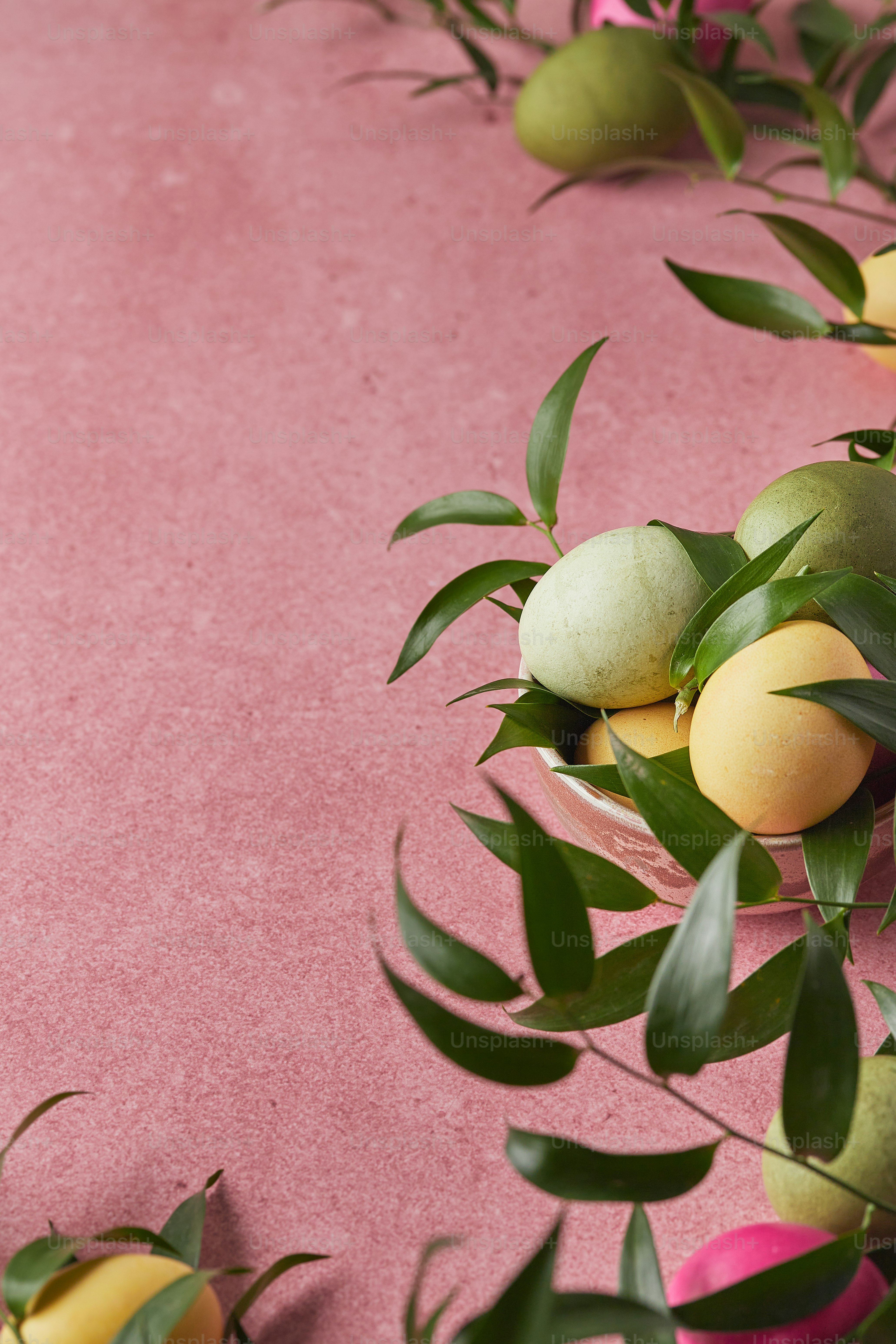 a bunch of fruit sitting on top of a pink surface