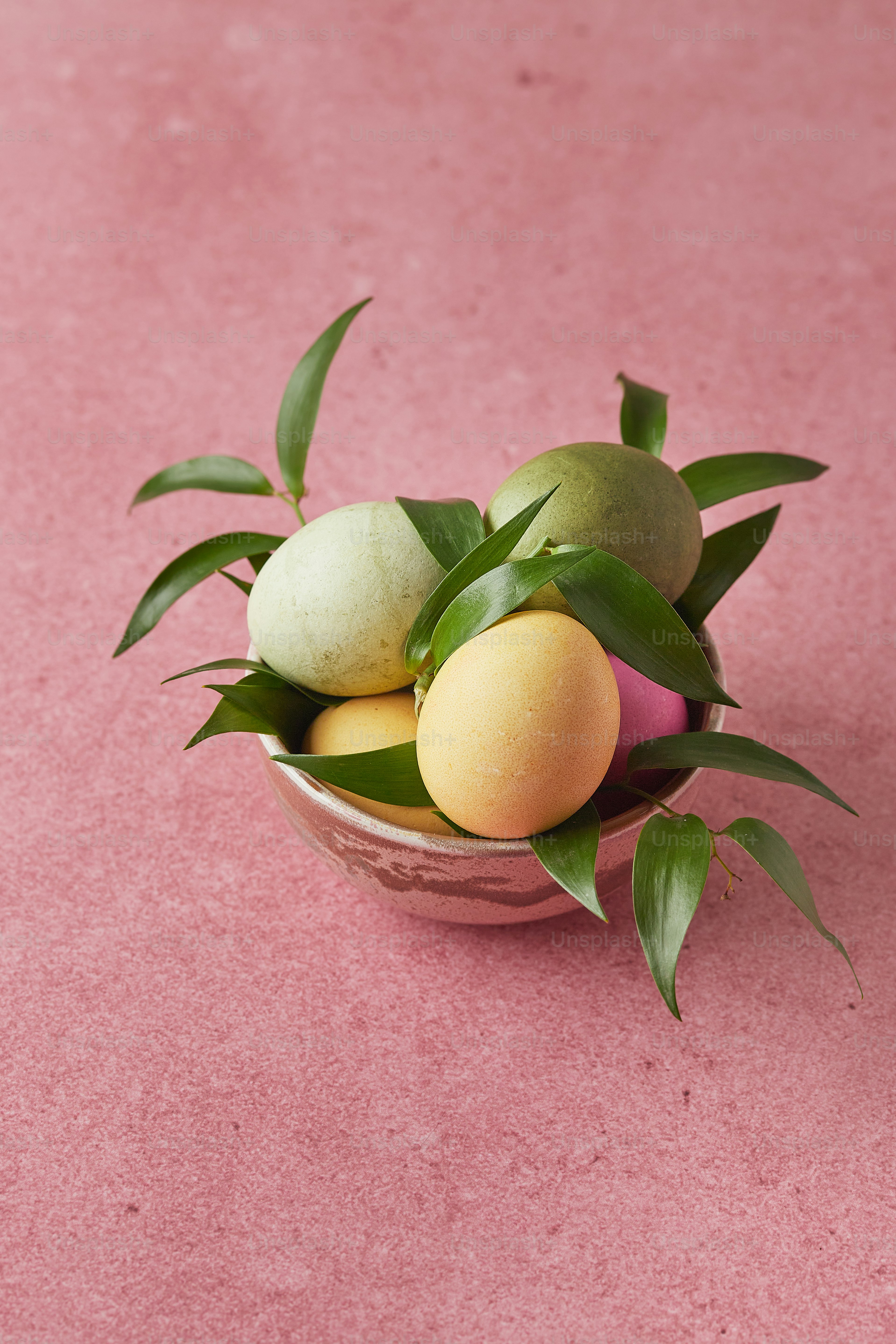 a bowl filled with fruit sitting on top of a pink floor