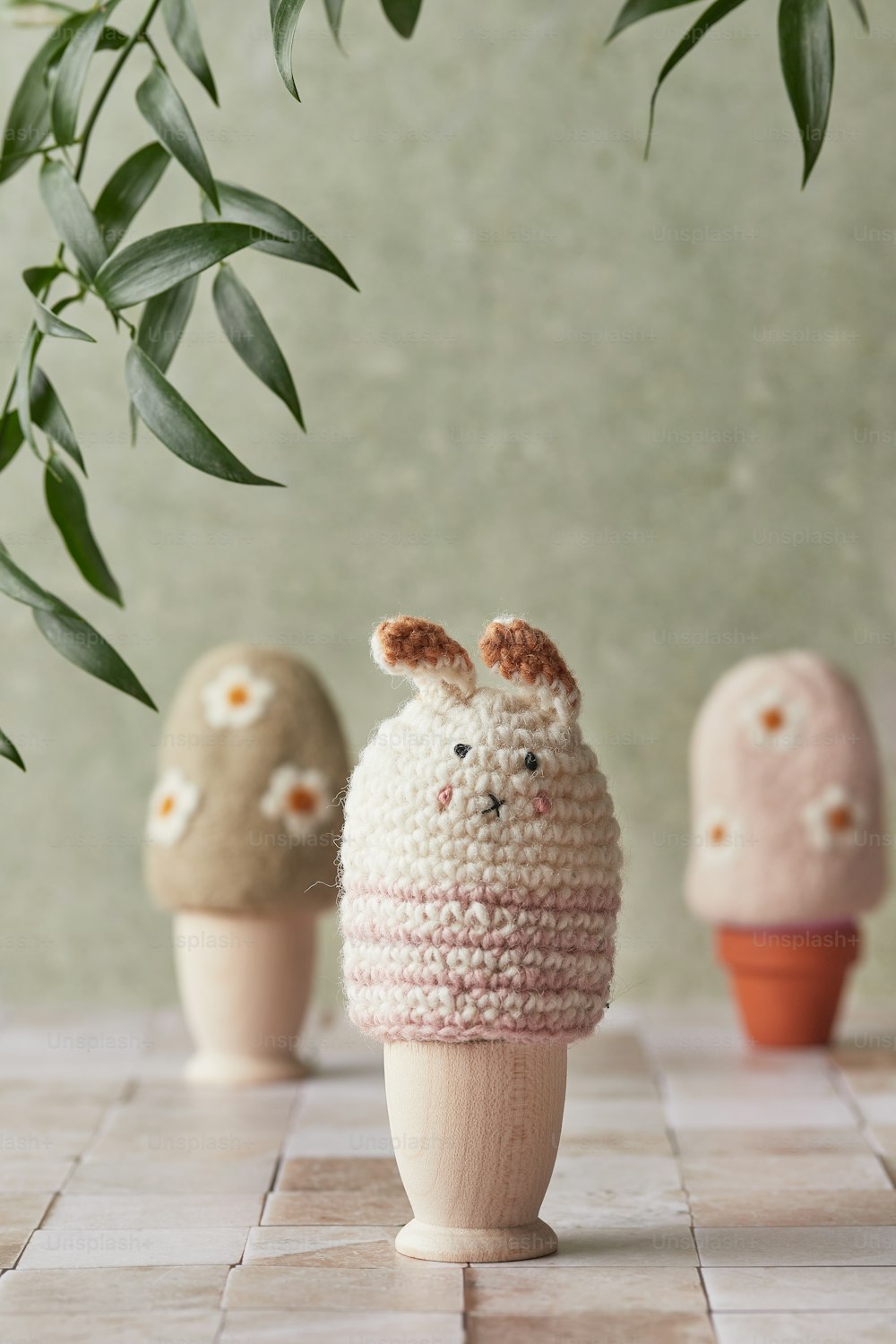 a group of small crocheted animals sitting on top of a tiled floor