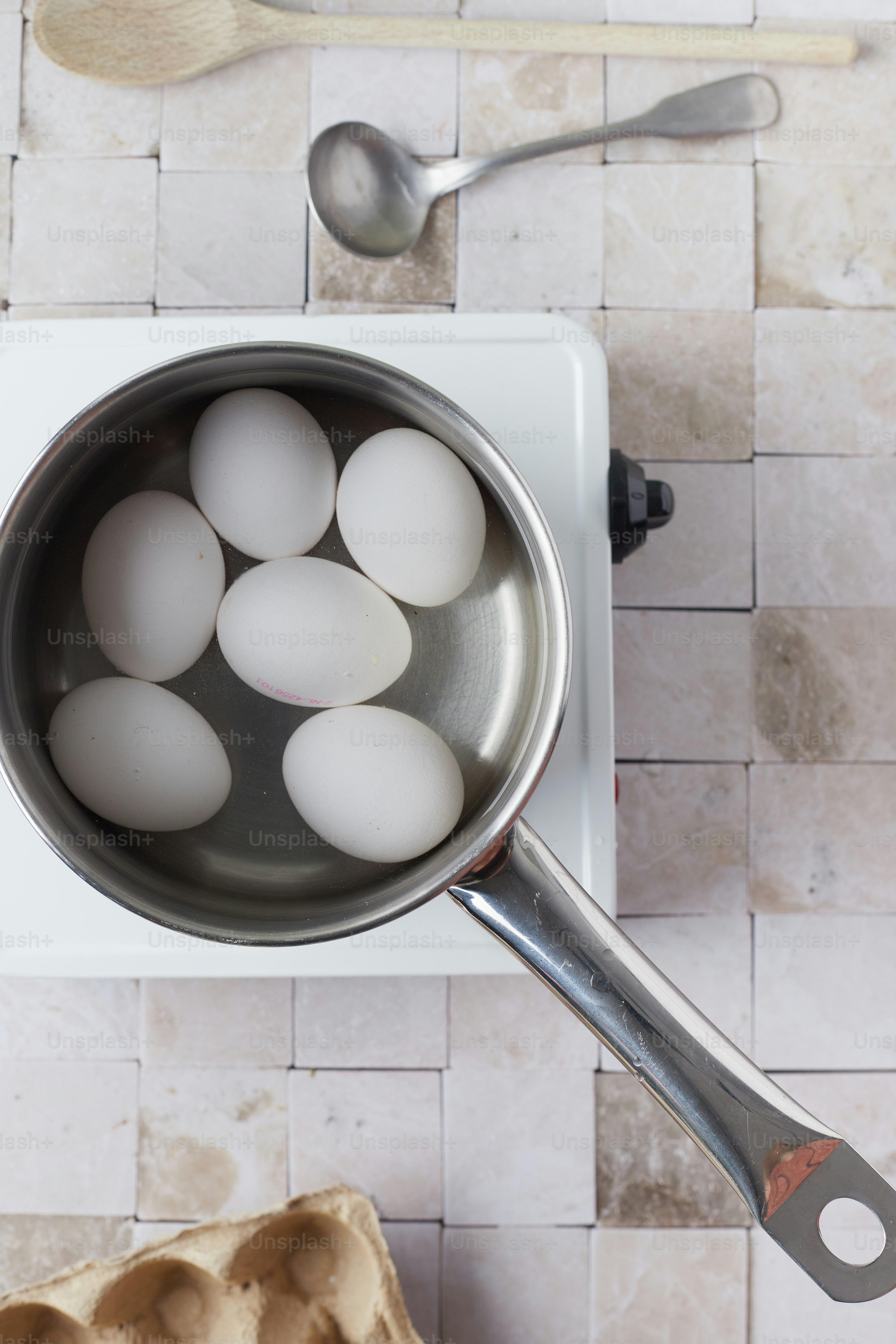 A pan filled with eggs on top of a stove photo – Kitchen Image on Unsplash