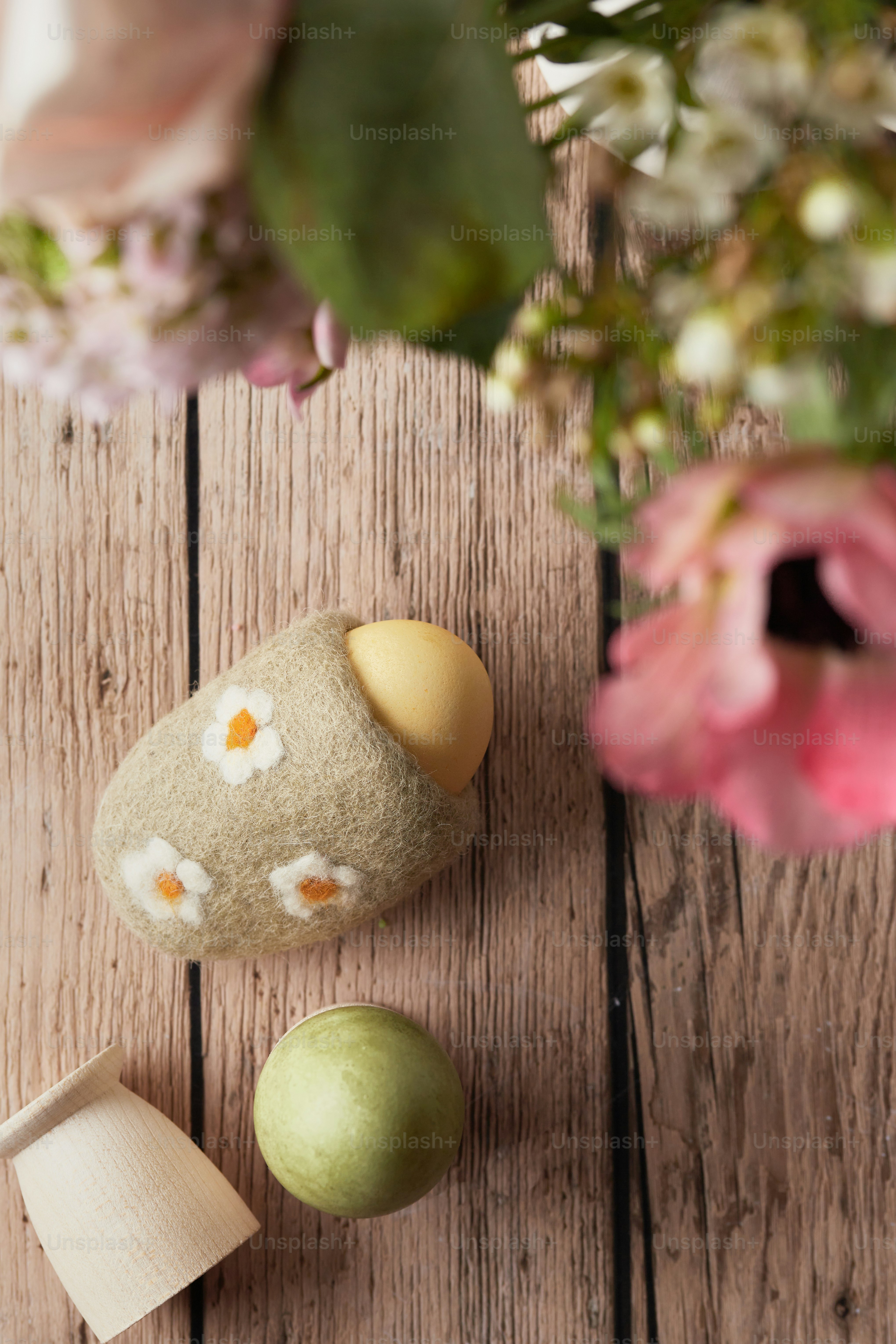 a wooden table topped with a vase filled with flowers