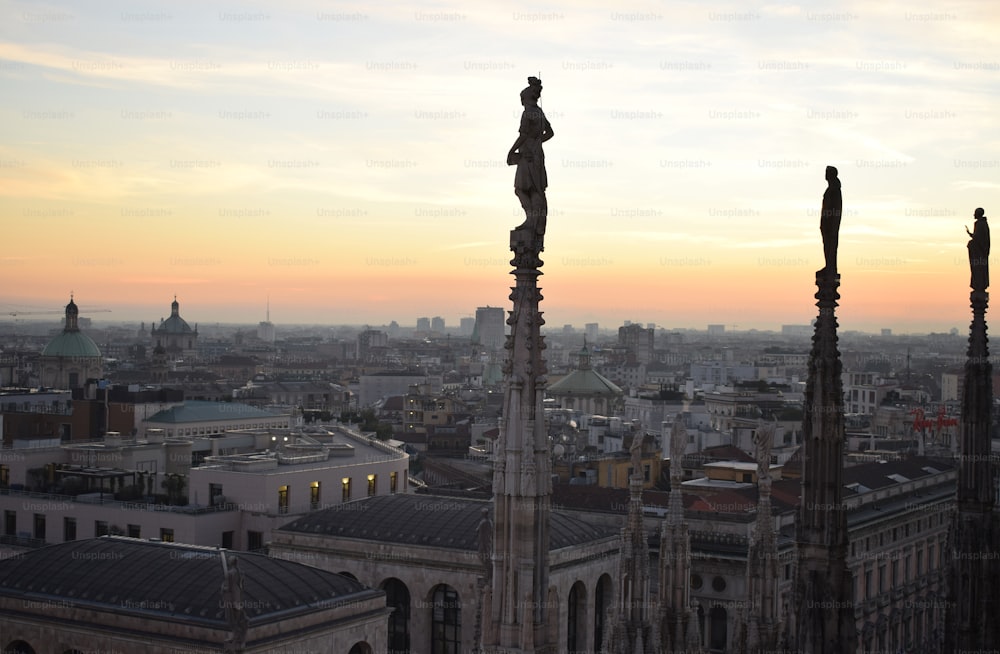 Eine Statue auf einem Gebäude mit einer Stadt im Hintergrund