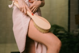 a woman brushing her legs with a brush