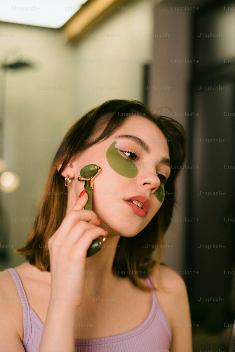 uma mulher segurando um objeto verde na frente de seu rosto