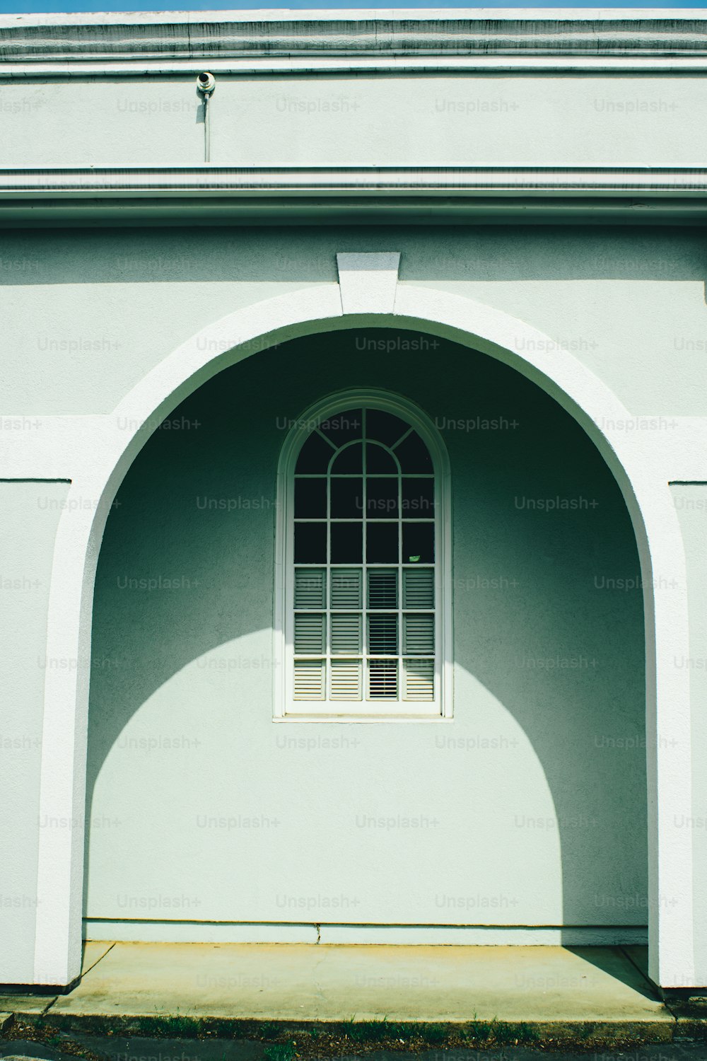 a white building with a window on the side of it
