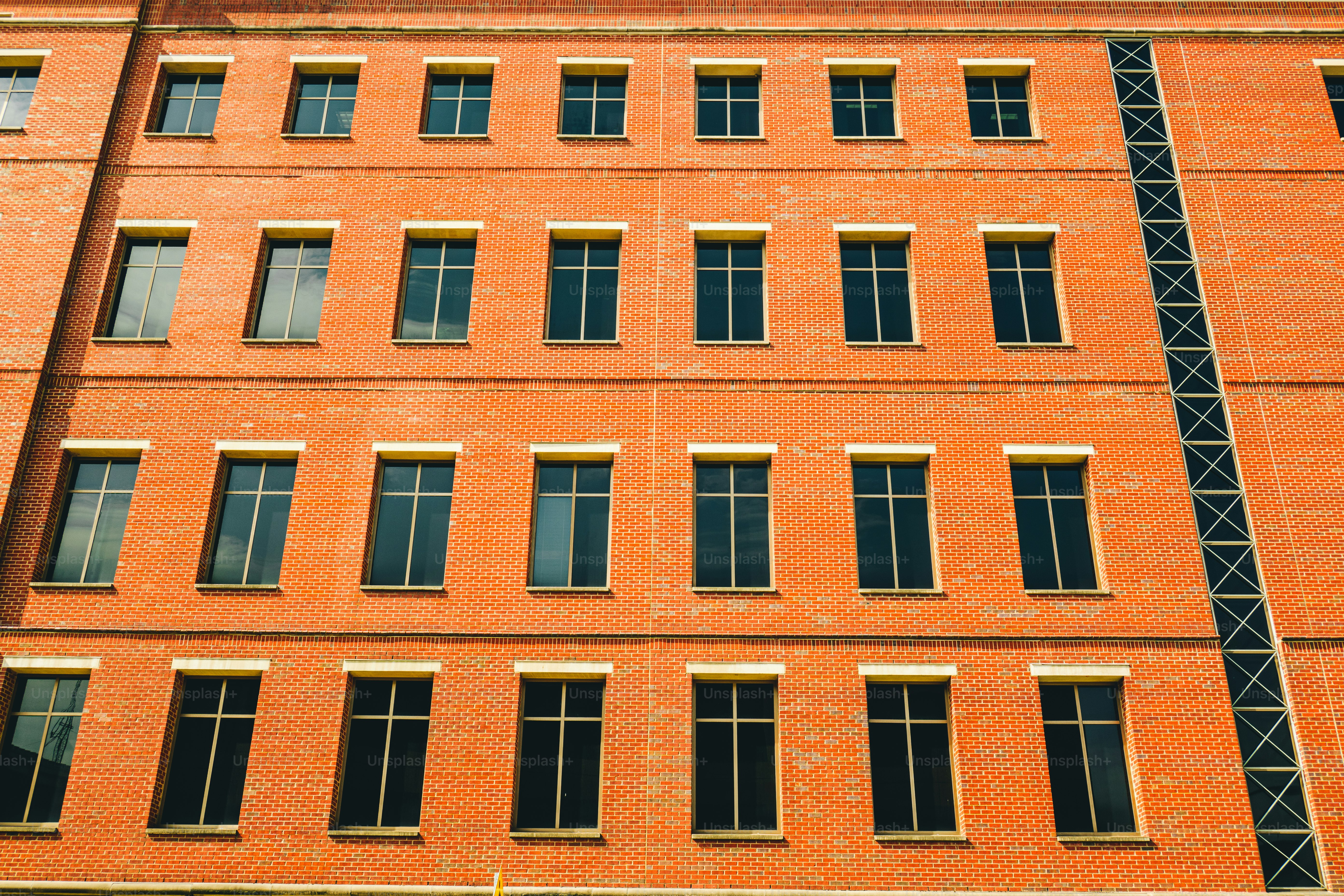 a red brick building with many windows and a clock
