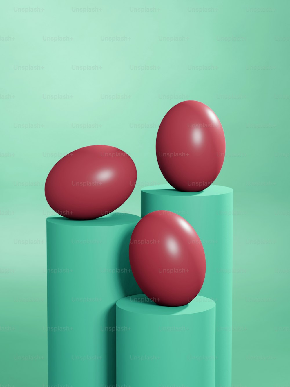 two red balls sitting on top of two green cylinders