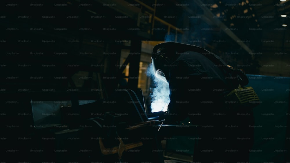 a person standing in a dark room with smoke coming out of his back