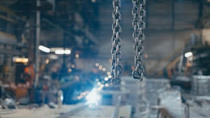a chain hanging from a machine in a factory