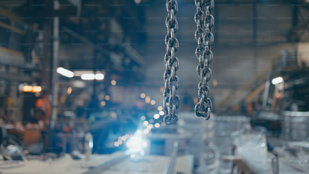 a chain hanging from a machine in a factory