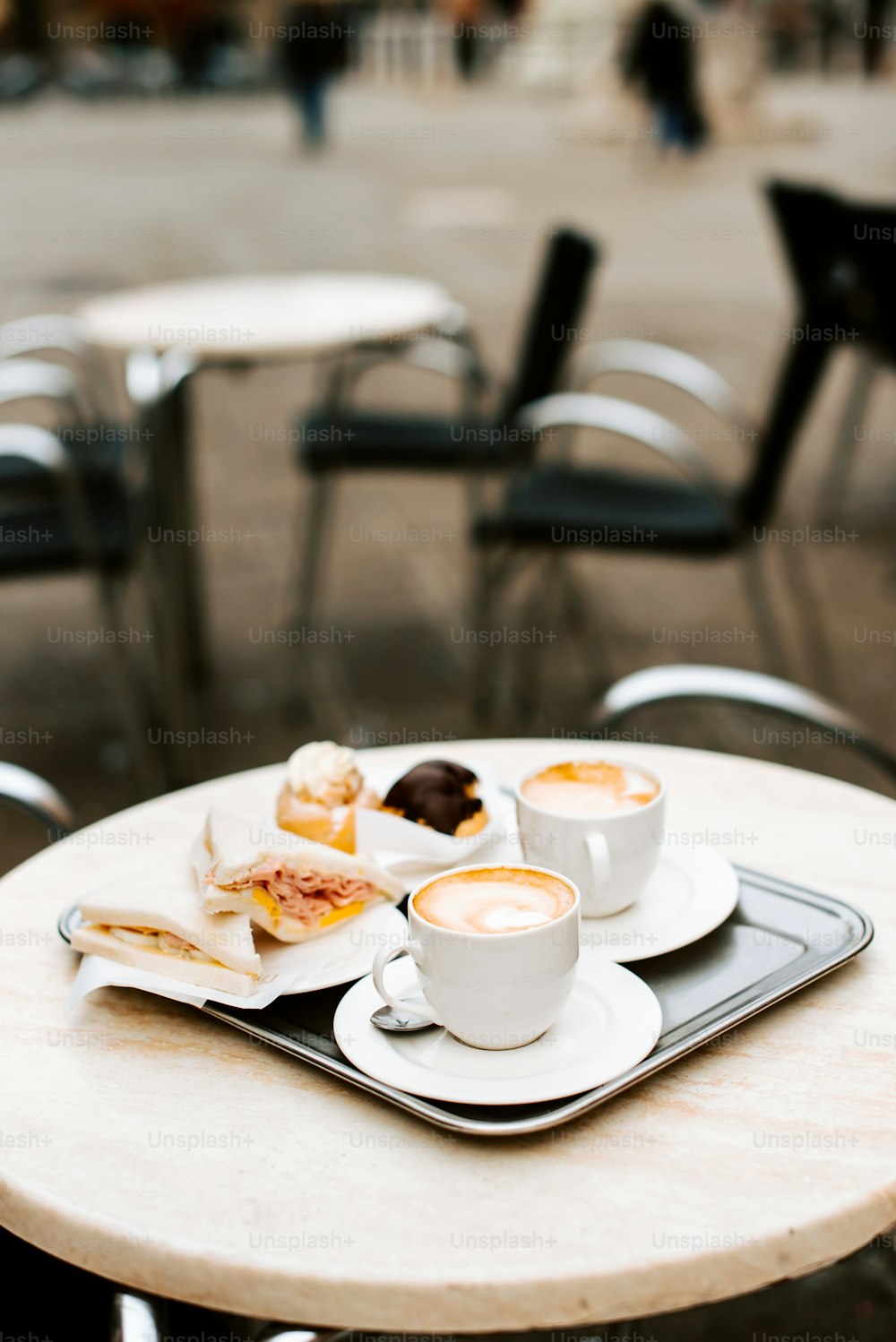 a table topped with plates of food and cups of coffee