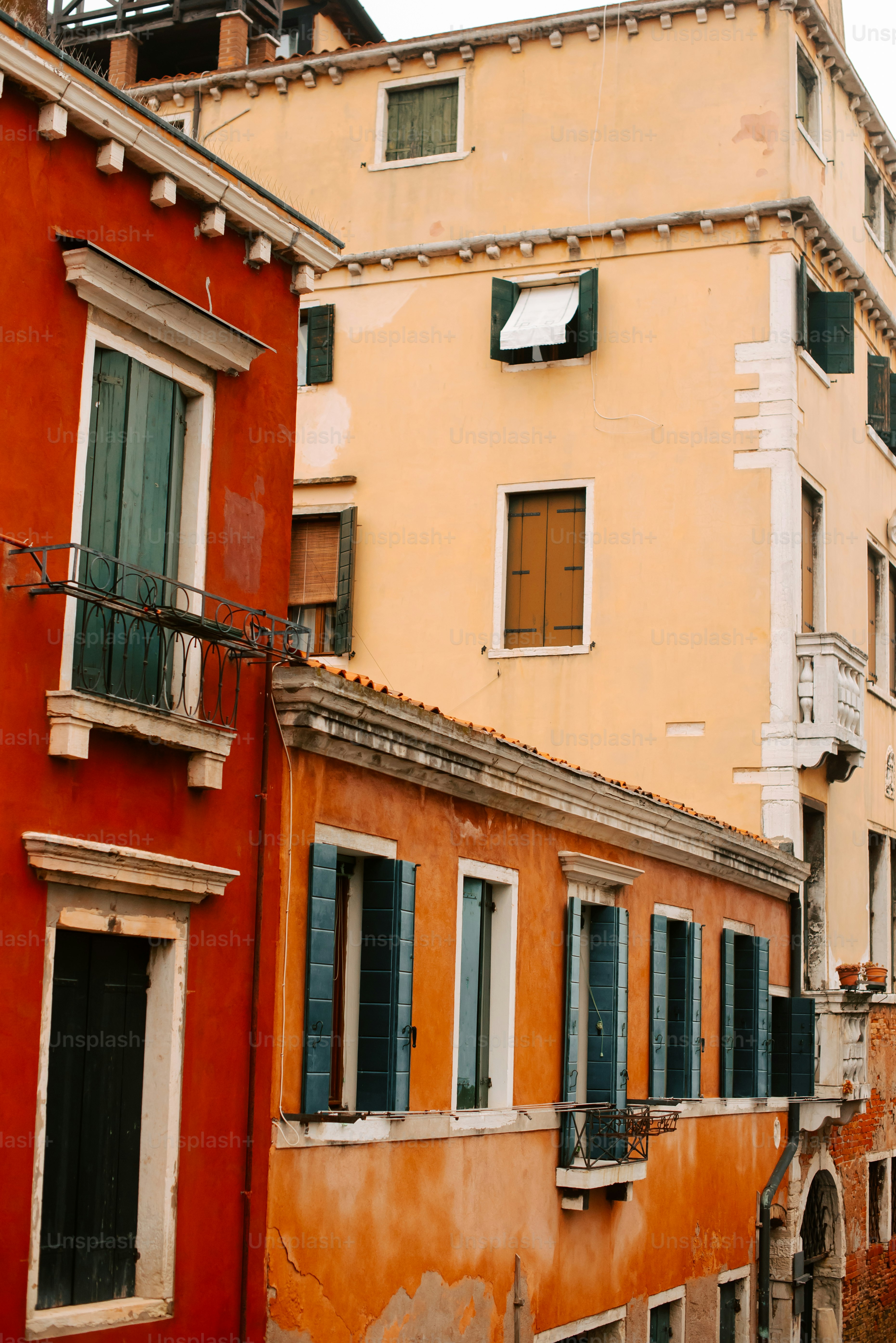 a row of buildings with balconies and shutters