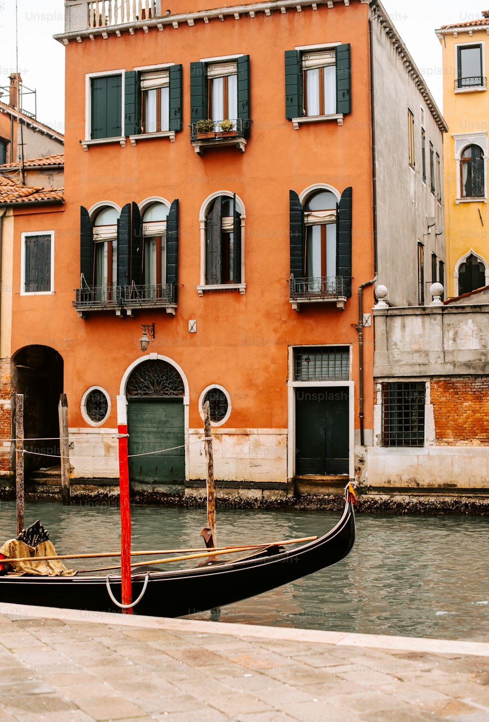 a gondola in front of a building on a canal