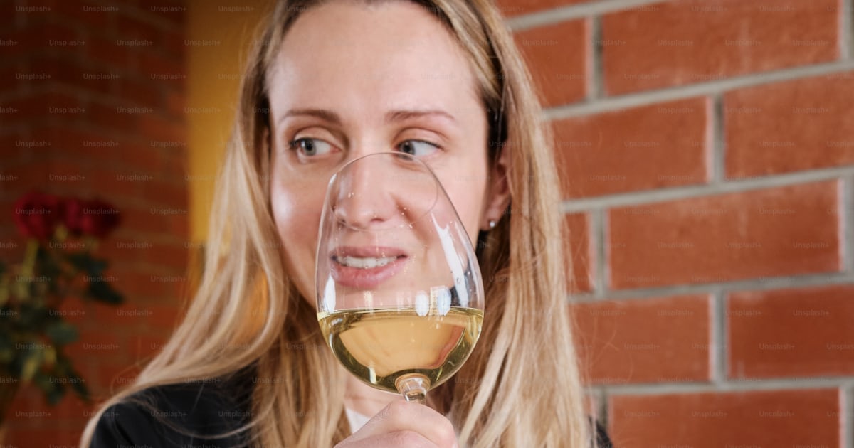 A Woman Holding A Glass Of White Wine Photo Wine Tasting Image On a-woman-holding-a-glass-of-white-wine-photo-wine-tasting-image-on