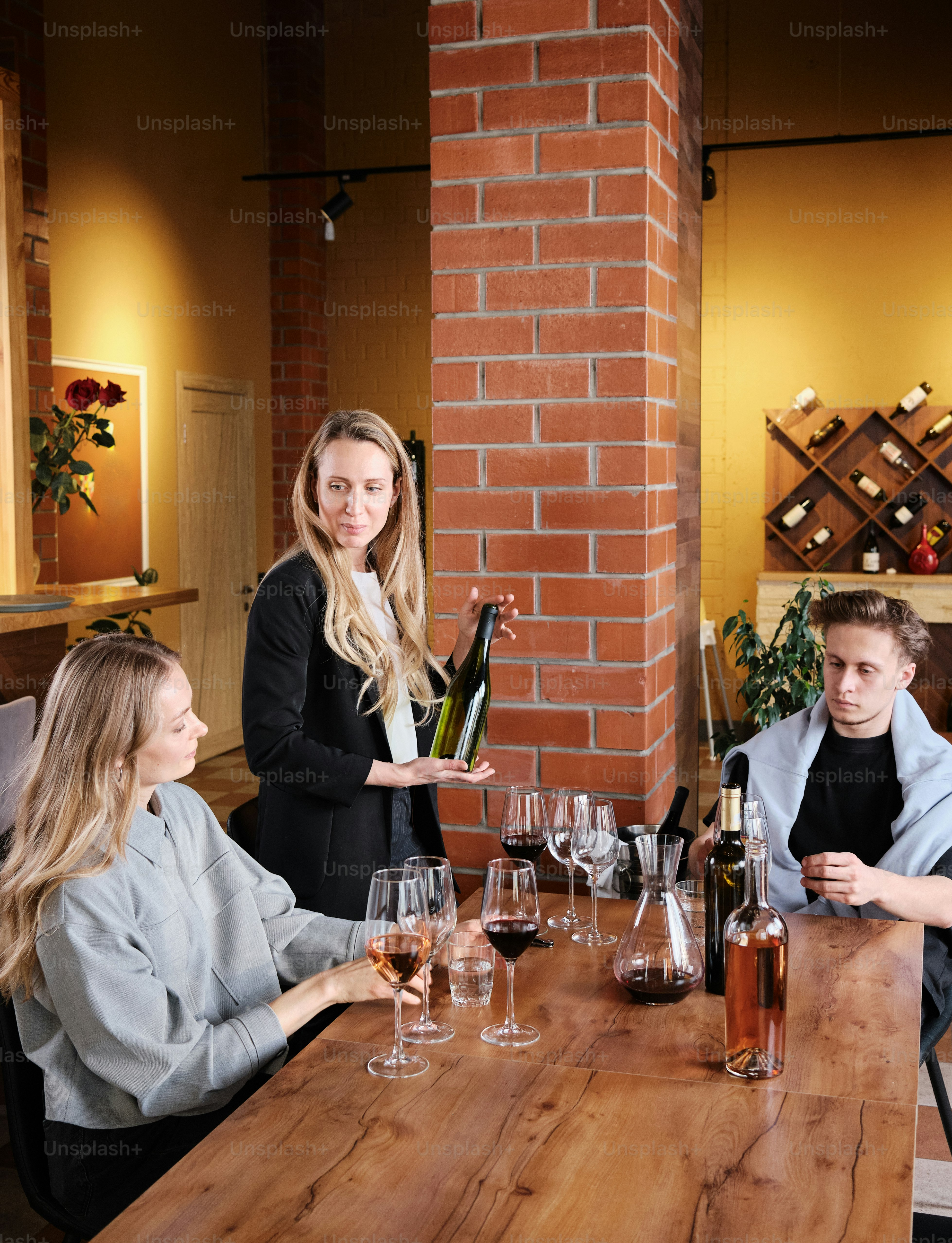 a group of people sitting around a wooden table