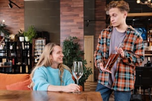 a man holding a wine glass next to a woman