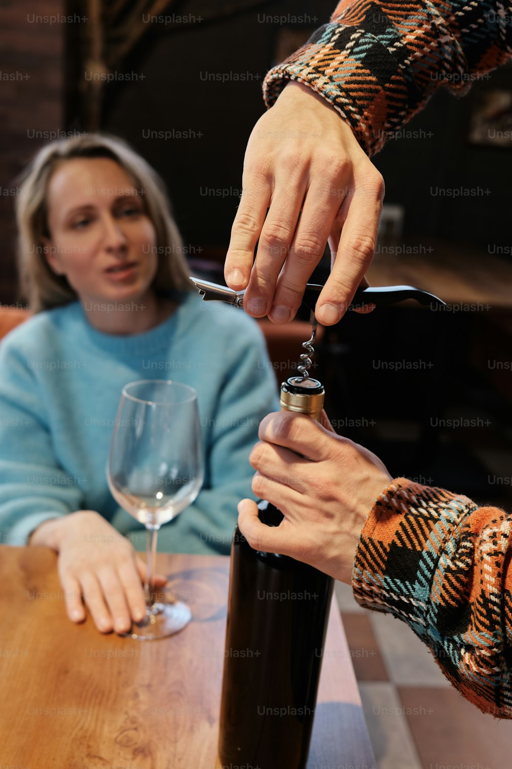 a woman is pouring wine into a wine glass