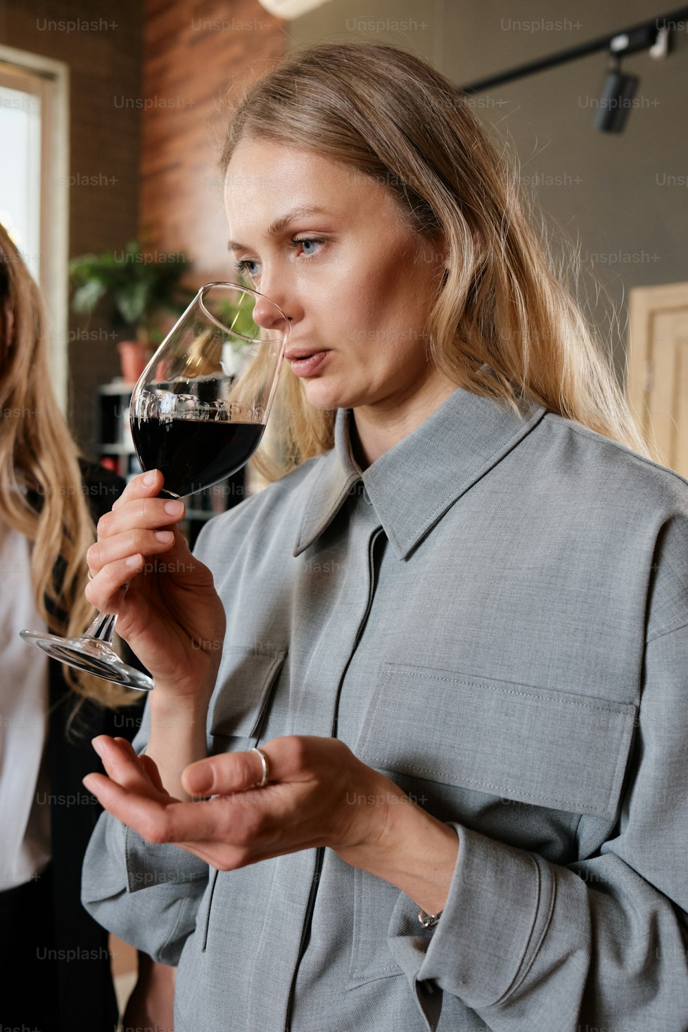 a woman is holding a glass of wine