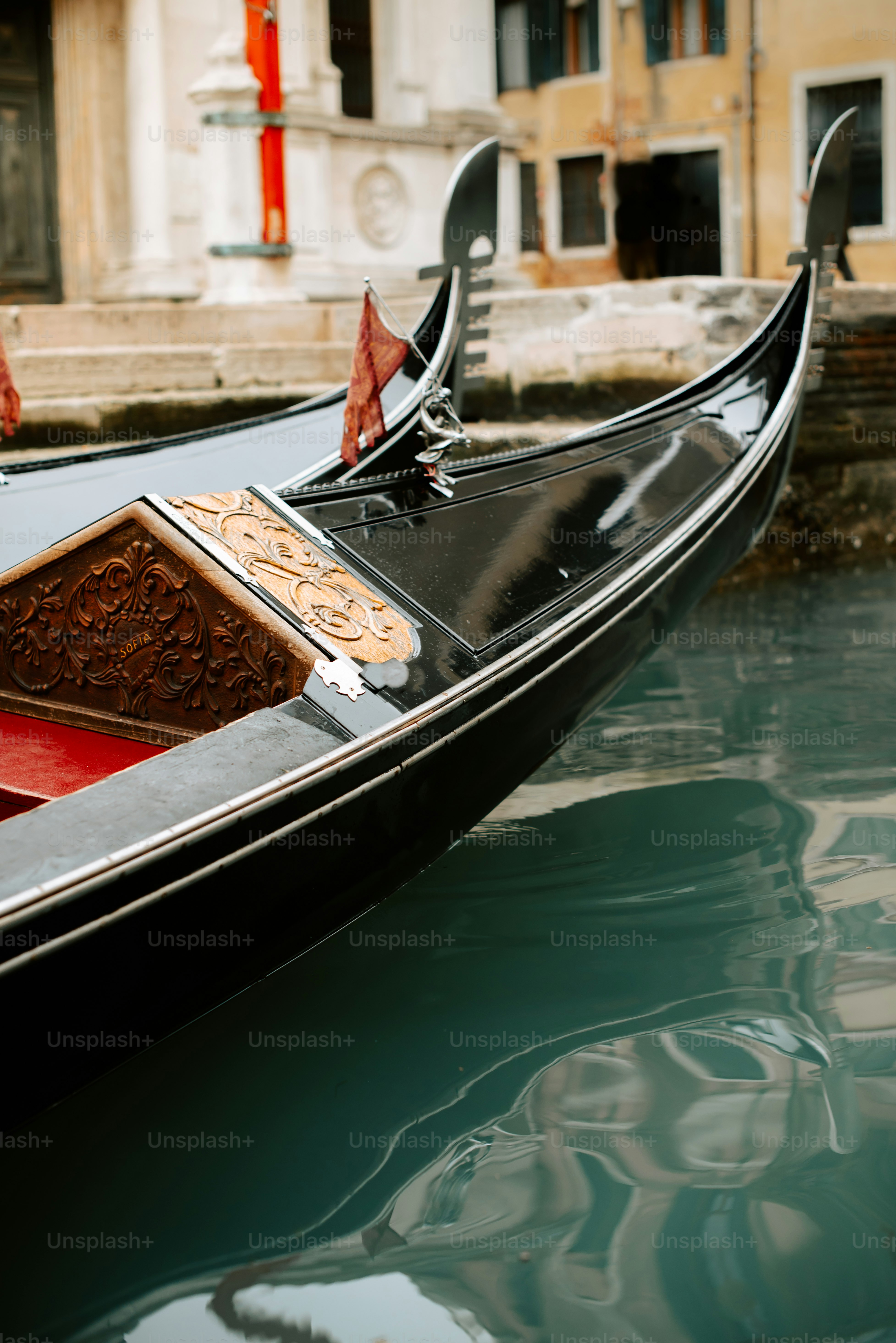 a gondola in a canal with a building in the background