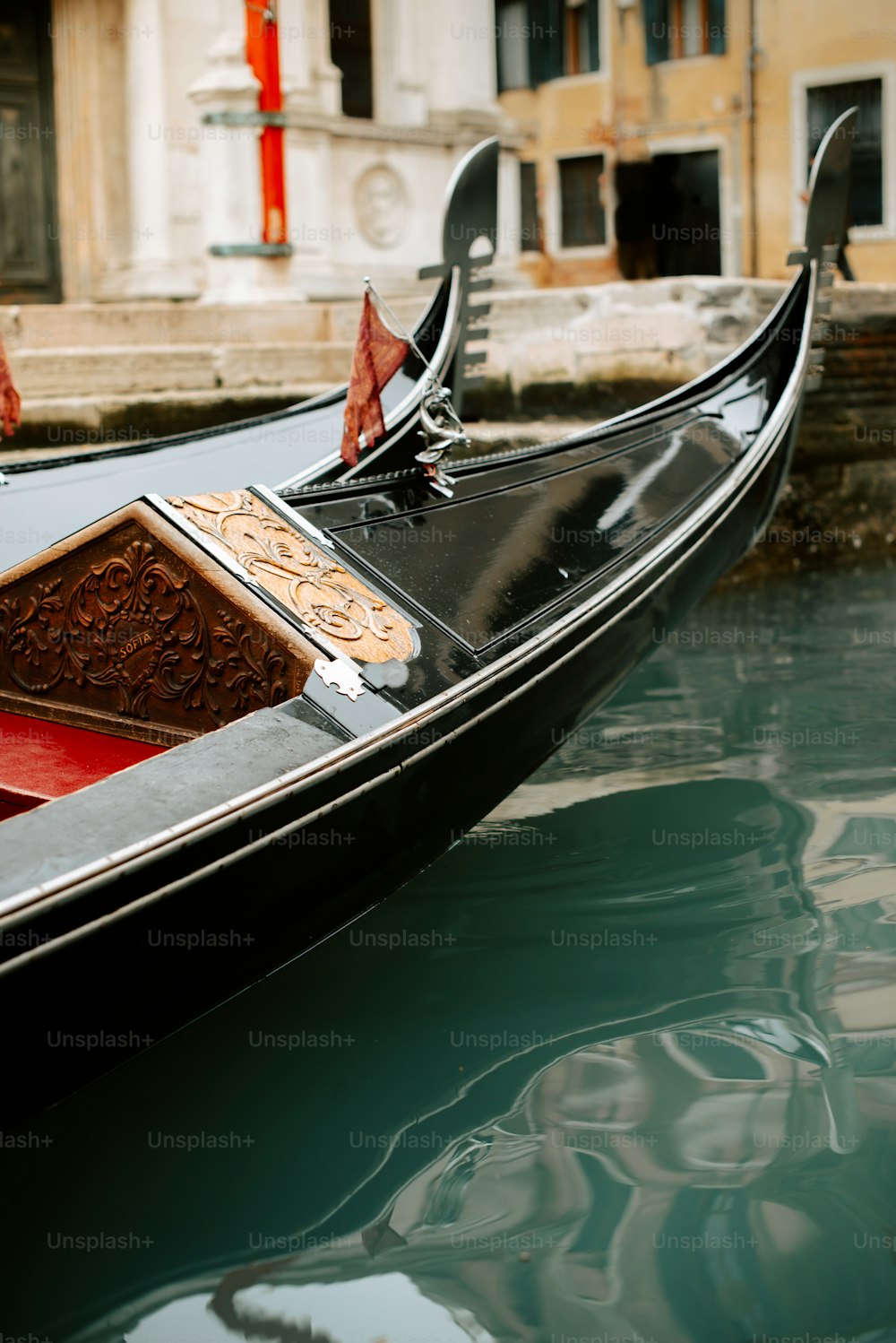 a gondola in a canal with a building in the background